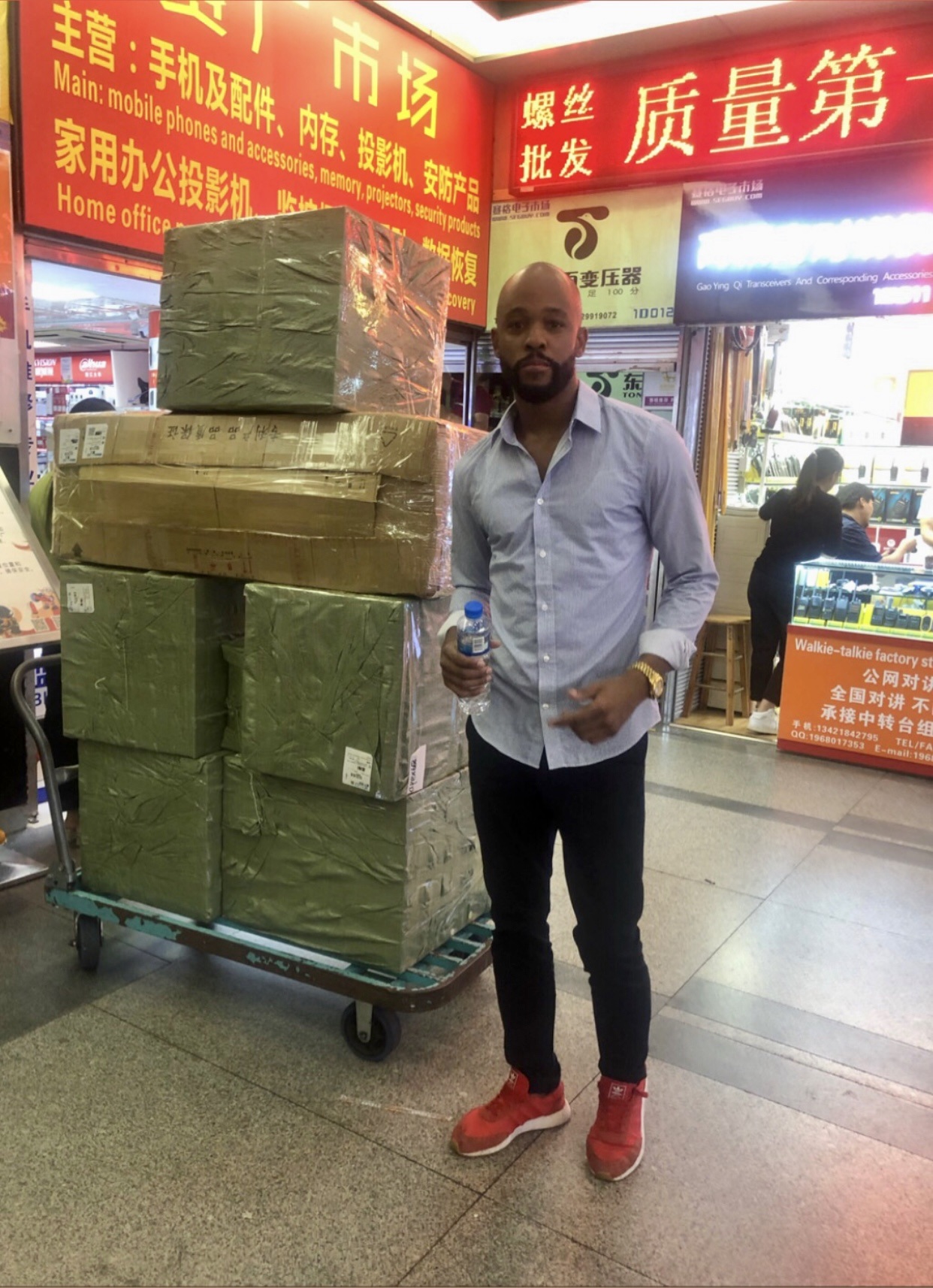 James beside a shipment of ecommerce products during a sourcing visit in China